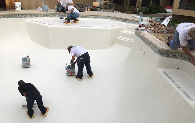 multiple doing the remodeling of a pool