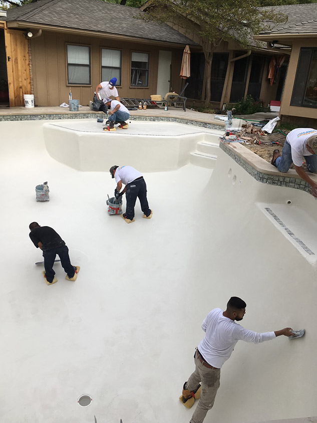 multiple doing the remodeling of a pool