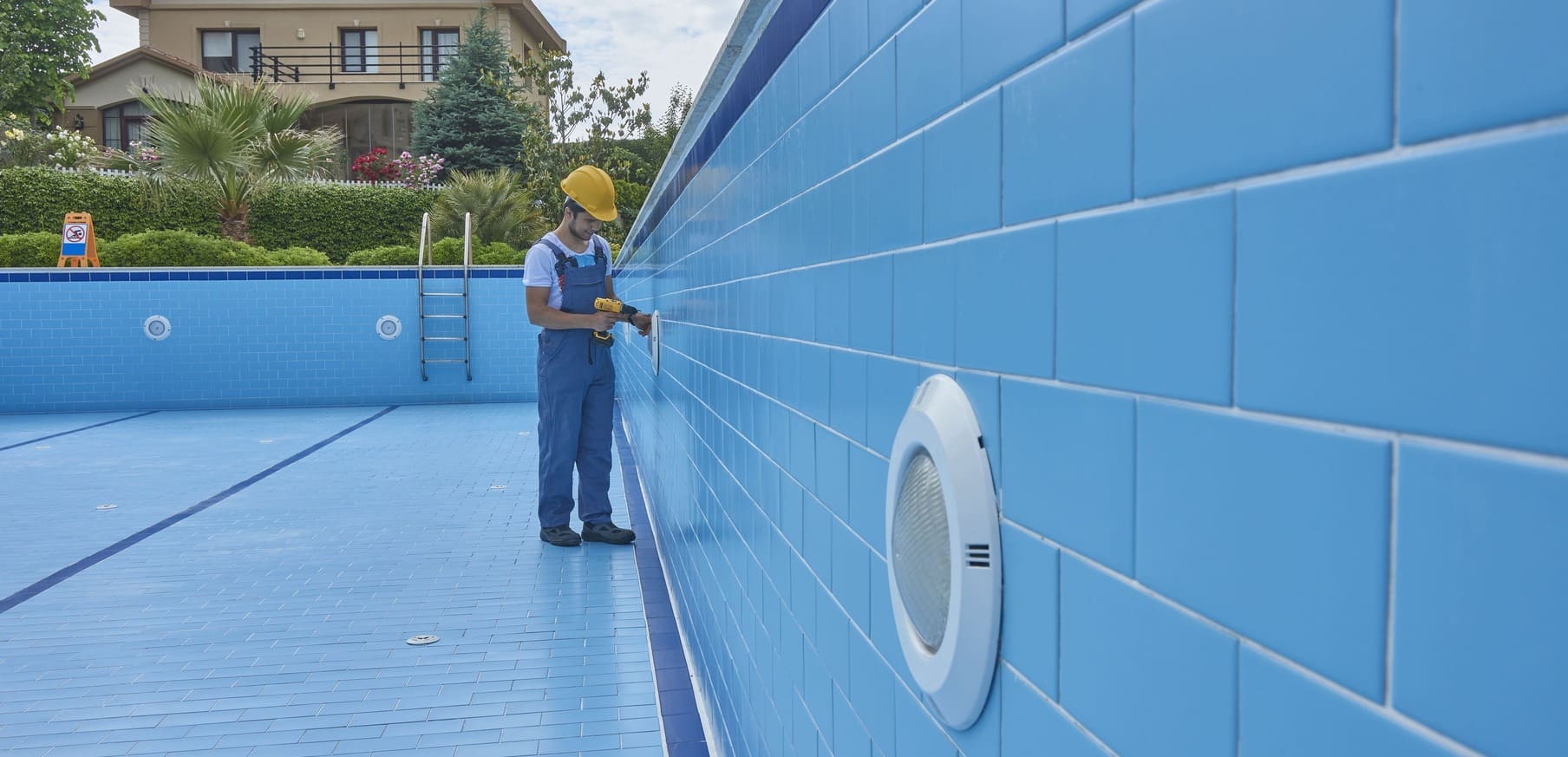 Manuel pools services repairman is repairing pool with equipment. Pool maintenance